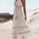 Boho Chic White Lace Maxi Dress worn by a bride, featuring intricate lace detailing on the shoulders and sleeves, perfect for a summer beach wedding.