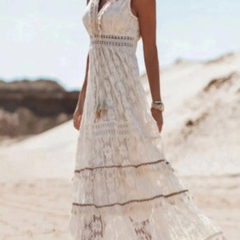 Boho Chic White Lace Maxi Dress worn by a bride, featuring intricate lace detailing on the shoulders and sleeves, perfect for a summer beach wedding.