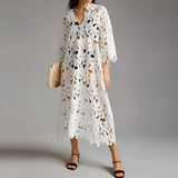 White lace midi dress with floral crochet design, featuring a V-neck, short sleeves, and a fitted waist. The dress is styled in a boho chic fashion and is displayed in size 2XL.