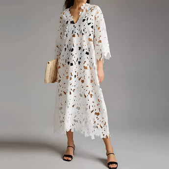 White lace midi dress with floral crochet design, featuring a V-neck, short sleeves, and a fitted waist. The dress is styled in a boho chic fashion and is displayed in size 2XL.