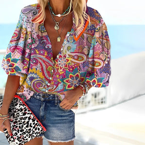 
A colorful paisley summer blouse for women, featuring a boho chic style in pink, designed with a relaxed fit for size 5XL. The blouse showcases a variety of vibrant patterns on a lightweight fabric, with short sleeves and a round neckline.