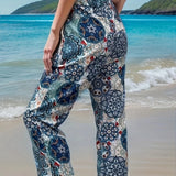 Bohemian-style floral beach culottes in a lightweight fabric with a tie-waist, suitable for summer, displayed against a backdrop of sky and water.