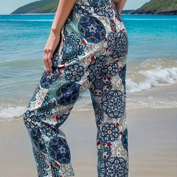Bohemian-style floral beach culottes in a lightweight fabric with a tie-waist, suitable for summer, displayed against a backdrop of sky and water.