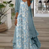 Boho Floral Maxi Dress with Cardigan in teal, featuring an asymmetrical two-piece design. The dress is displayed in a blue color, size XXL, highlighting its jointed style with distinct shoulder and neck details. It is surrounded by a white background, with a plant in a flowerpot nearby.