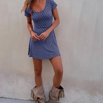 Boho tribal print mini dress in white with a V-neckline, featuring short sleeves and a fedora hat accessory, perfect for summer festivals; shown in XL size.