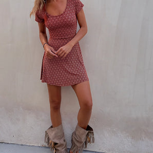 
A red boho tribal print mini dress with a V-neck design, featuring short sleeves. The dress is styled for summer festivals and is shown in an XL size.
