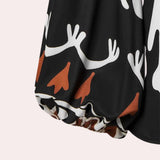 Long-sleeve jumpsuit with bold floral patterns in orange, black, and white, featuring a belted waist design.