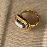 Gold adjustable statement ring with large reflective gemstone, fashion accessory.