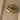 Gold adjustable statement ring with large reflective gemstone, fashion accessory.