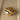 Bold gold adjustable statement ring featuring a large reflective gemstone.