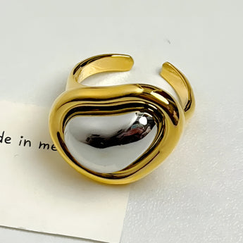 Bold gold adjustable statement ring with large reflective gemstone, resizable.