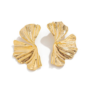 Oversized botanical statement earrings with a bold textured gold leaf design.