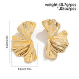 Oversized botanical gold leaf statement earrings with bold texture, designed in the shape of butterfly wings.