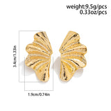 Bold Textured Gold Leaf Statement Earrings styled in a butterfly-inspired design with intricate gold detailing and symmetrical wings.