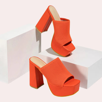 Bright orange ankle boots with a stretch fit sock design and neon details, shown in size 40.