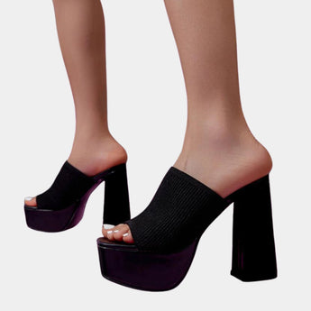 Bright orange ankle boots with a stretch fit sock design and neon detailing, highlighting their stylish and vibrant appearance.