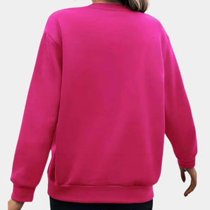 Bright oversized women's pink sweatshirt with long sleeves, featuring a comfortable and casual pullover design, highlighted by the soft fabric and relaxed fit.
