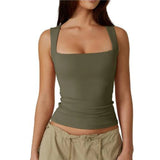 
A woman wearing a green moisture-wicking yoga tank top, showcasing athletic wear designed for comfort during exercise. The tank features a sleeveless design, with emphasis on the arm and chest areas, and is paired with grey workout leggings.