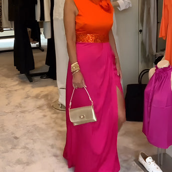 Bright pink palazzo pants paired with an orange silk blouse showcasing a stylish summer chic outfit.