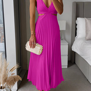 A woman wearing a bright pink v-neck pleated midi dress, ideal for cocktail and evening wear, with shoes completing the fashionable look.