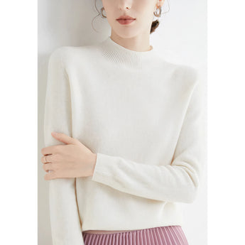 A bright red women's cashmere crew neck sweater, worn by a person, showcasing winter fashion with long sleeves and a cozy fit.