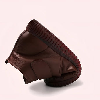 Brown leather ankle boots with a zippered design, featuring a sturdy non-slip sole, ideal for equestrian activities.