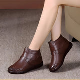 Brown leather ankle boots with a zippered side and non-slip sole, designed as equestrian gear, shown on a person's feet and legs.
