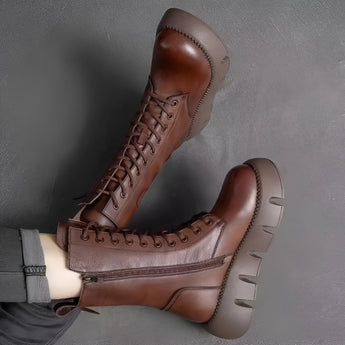 Brown leather high-top military combat boots with a rugged and stylish design, featuring durable construction and a classic lace-up style.