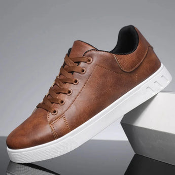 Dark brown low-top men's sneakers made of leather with a stylish design, featuring a versatile white sole.