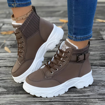 Brown platform chunky lace-up ankle boots displayed on a model's feet, showcasing fashion hiking footwear for a stylish and practical look.