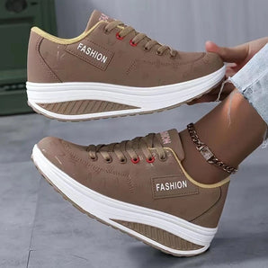 
A pair of stylish and comfortable brown platform sneakers for women, featuring a sleek design suitable for walking and outdoor activities.