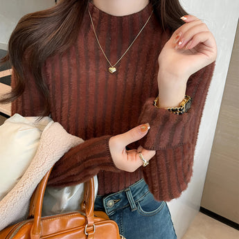 Brown ribbed sweater paired with gold earrings, showcasing cozy fall fashion; features a dark brown color, full sleeves, and a focus on the shoulder and neck area.