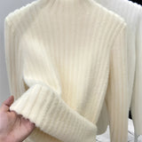 Brown ribbed sweater paired with gold earrings, showcasing a cozy fall chic style. The sweater features long sleeves and a comfortable fit, perfect for cooler weather. The gold earrings add a touch of elegance, complementing the casual yet fashionable ensemble.