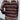 Brown striped women's knit sweater worn by a person, styled for fall fashion. The sweater features long sleeves and a cozy pullover design, paired with jeans. The image captures the upper body, highlighting the sweater's texture and pattern.
