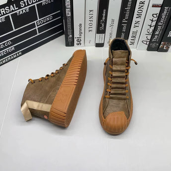 Brown suede high-top sneakers with a ribbed sole displayed against a wooden background, showcasing stylish urban footwear design.