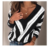 Brown and white V-neck striped knit sweater for women, shown in black color, designed as a casual pullover. The image features a plus-size model wearing the 3XL size, highlighting the sweater's long sleeves and comfortable fit. The model is paired with jeans, showcasing a relaxed and stylish outfit.