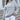 Brown and white zigzag patterned crew neck women's sweater, shown on a model, highlighting the autumn fashion knit design.