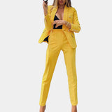 Brown women's suit featuring a deep v-neck blazer and fitted trousers, shown in yellow color and XL size, with focus on outerwear design elements like sleeves, waist, and collar.