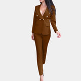 
An elegant brown women's suit featuring a deep V-neck blazer with long sleeves and fitted trousers, showcasing a tailored fit around the waist and thighs. The outfit is in the color brown and available in size XL.