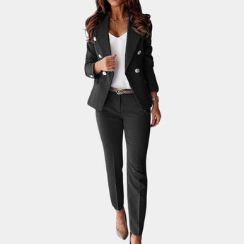 Brown women's suit featuring a deep V-neck blazer and fitted trousers, highlighting the shoulder, waist, and leg areas.