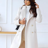 Brown wool double-breasted coat with gold buttons designed for women's winter fashion, featuring a classic trench coat style with a structured collar, long sleeves, and a tailored fit at the waist.