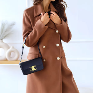 Brown wool double-breasted coat with gold buttons for women in a khaki color, featuring a tailored fit, long sleeves, and a structured shoulder design, suitable for winter fashion. Model is standing to showcase the coat's length and style, available in size 2XL.