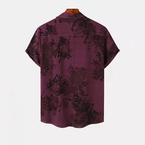 Burgundy floral men's short sleeve shirt featuring a vintage botanical pattern with a collar and button-up design.