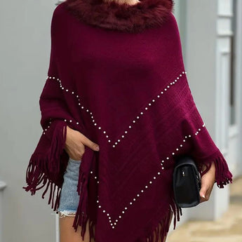 Burgundy women's poncho featuring a luxurious fur collar and pearl embellishments, styled for winter wear.