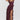 A woman wearing a burgundy off-shoulder ruffle maxi dress made of chiffon, featuring an elegant asymmetric design. The dress is sleeveless with a fitted waist, showcasing a stylish and flowing silhouette suitable for formal occasions.