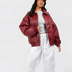 Burgundy oversized leather bomber jacket for women, featuring a stylish fall design with long sleeves, a defined waist, and a classic collar.