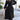 Burgundy pleated midi wrap dress with an elegant V-neck and tie waist, styled in a Nero color and XL size, featuring long sleeves and a flowing skirt. The dress is displayed on a mannequin showcasing its flattering fit and contemporary design.