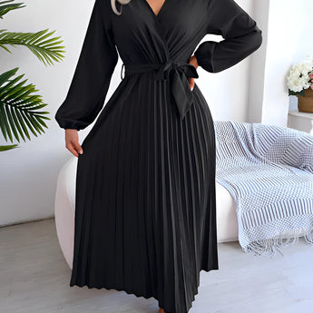 Burgundy pleated midi wrap dress with an elegant V-neck and tie waist, styled in a Nero color and XL size, featuring long sleeves and a flowing skirt. The dress is displayed on a mannequin showcasing its flattering fit and contemporary design.