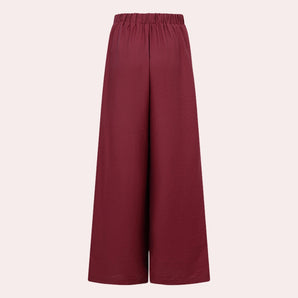 Burgundy women's high-waisted wide-leg palazzo pants with a smooth, flowing fabric and rich color, ideal for a stylish and comfortable look.