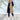 Burgundy women's long puffer coat with detachable hood in a khaki color, size 3XL, being worn by a person outdoors. The coat features long sleeves, a spacious fit around the waist and thighs, and a stylish trench coat design.